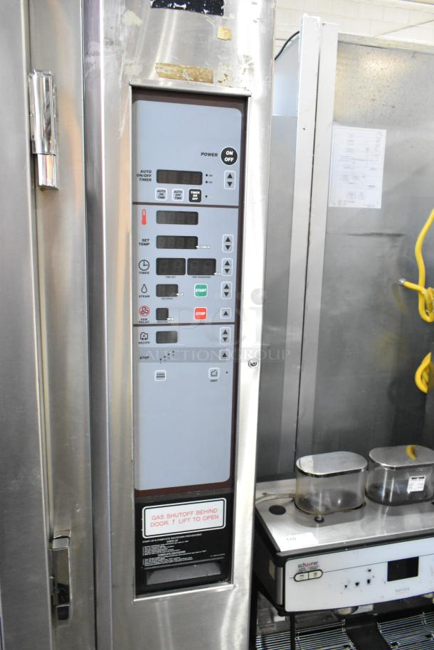 Baxter stainless steel rotating rack oven with digital controls on double pan rack, commercial casters, and gas shutoff label.