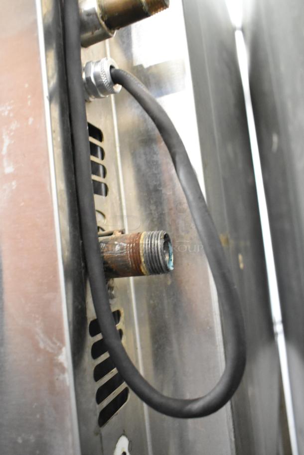 Baxter stainless steel mini rotating rack oven, gas-powered, shown with commercial casters and gas connection detail.