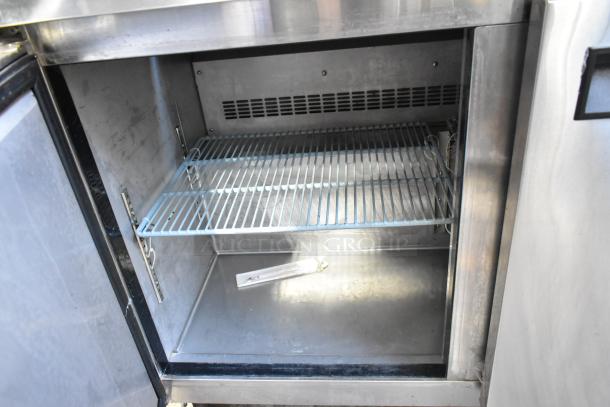 Dukers DSP48 stainless steel prep table interior, features wire shelf, commercial grade, visible clean condition, 115 volts.