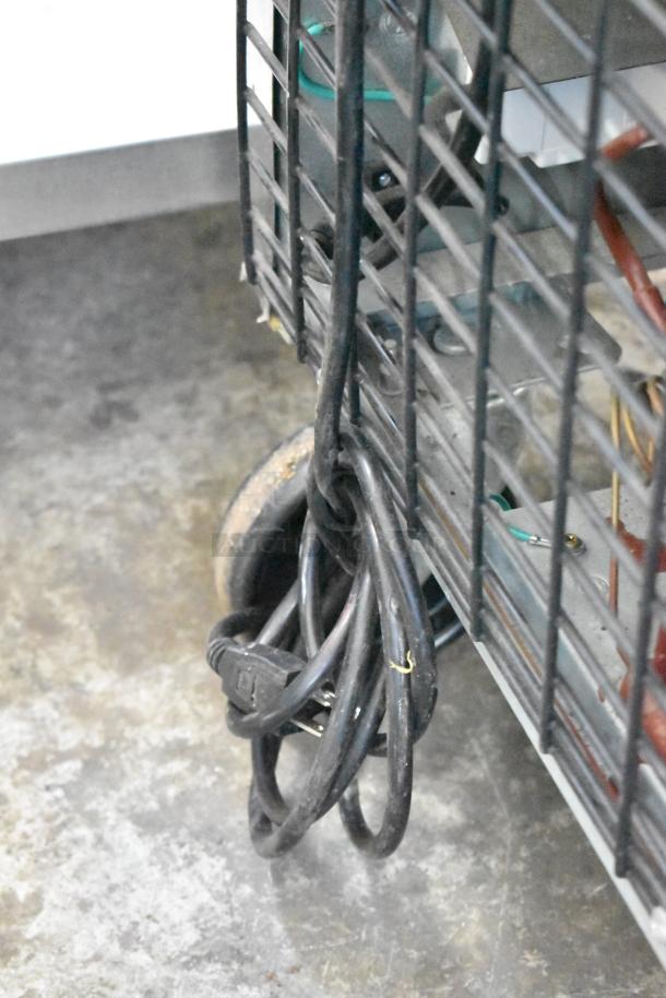 Dukers DSP48 prep table edge with power cord, commercial casters visible. Stainless steel design, one-phase, 115 volts.