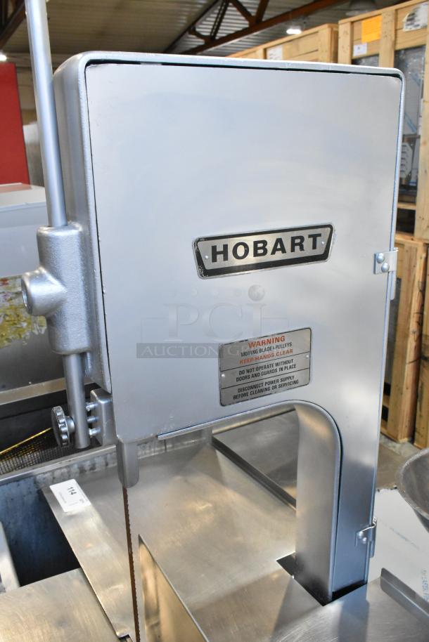 Hobart 5212 metal commercial floor-style meat saw, 200-230 volts, 3 phase. Features safety warnings and Hobart branding.