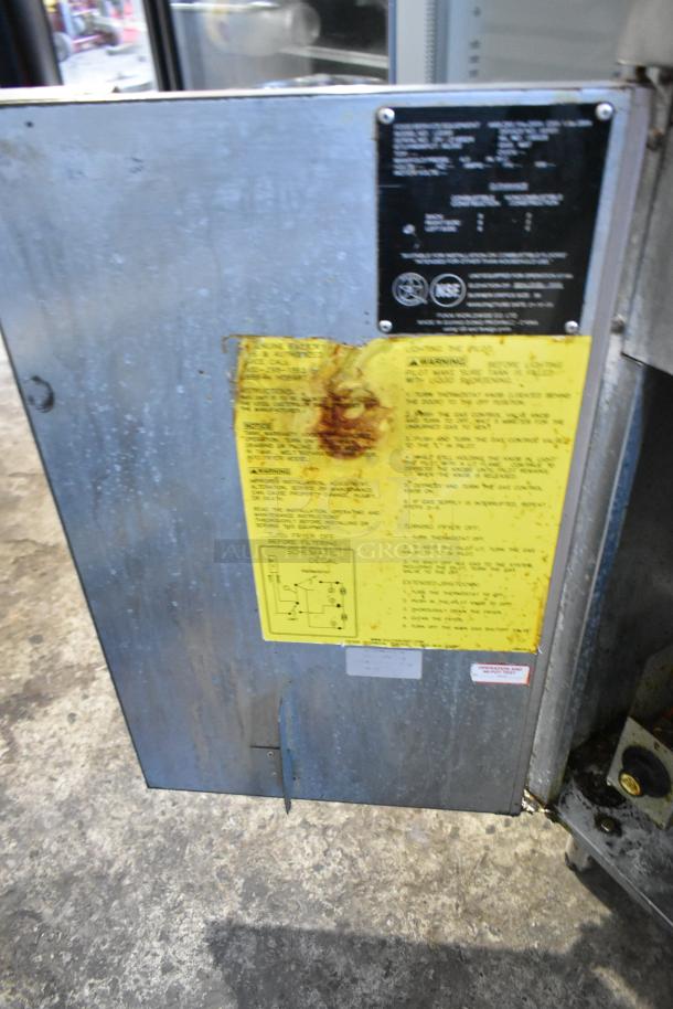 Vulcan LG300 stainless steel commercial deep fat fryer, natural gas, 90,000 BTU, with metal fry basket. Visible safety and instruction labels.