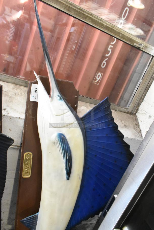 Two decorative plaques featuring a blue marlin and a sailfish with vivid detailing. Marked "Sailfish" on the plaque.