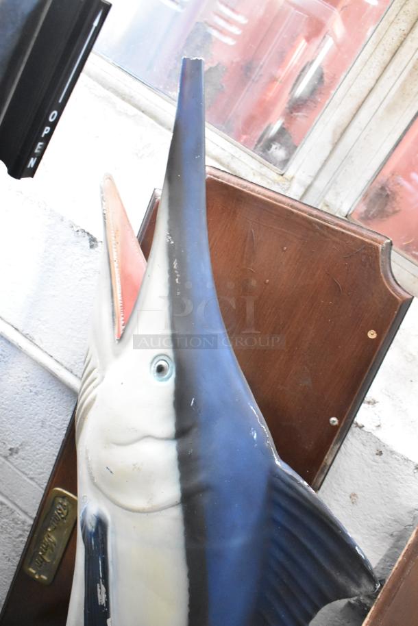 Decorative Blue Marlin fish on plaque, detailed painted finish, wooden backing, slight wear visible, auction item.