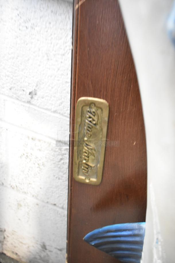 Decorative plaque featuring a Blue Marlin fish, with a brass label indicating its name. Appears in good condition.