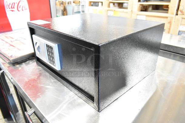 Black metal safe with keypad, no combination included, in good condition. Rectangular, textured finish.