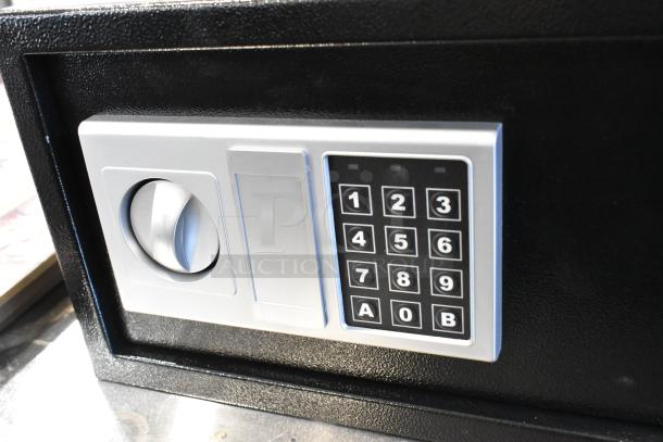 Black metal safe with electronic keypad, missing combination. Secure locking mechanism. Durable construction.