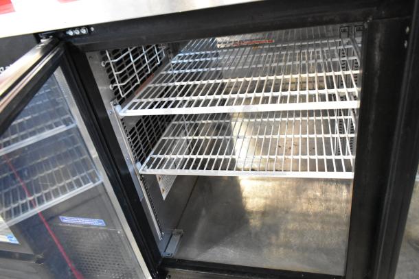 Turbo Air TBB-24-60SG-N commercial cooler, 2-door, interior metal shelves, 115V, clean condition, model label visible.