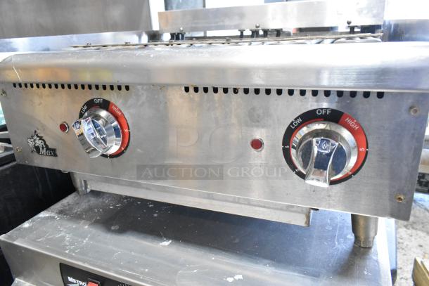 Star Max stainless steel electric charbroiler grill with dual control knobs, used condition, visible logo and settings.