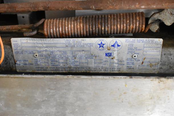 Garland M44R commercial gas range label, showing model and specifications, NSF certified, manufactured in Mississauga, Ontario.