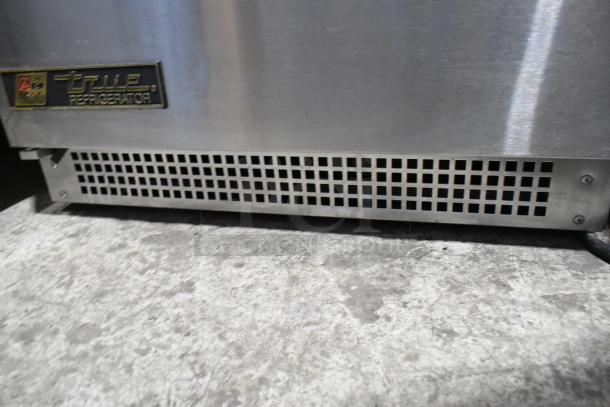 True TUC-24 stainless steel undercounter cooler, single door, 115V, 1 phase. Features logo plate and vent grille.