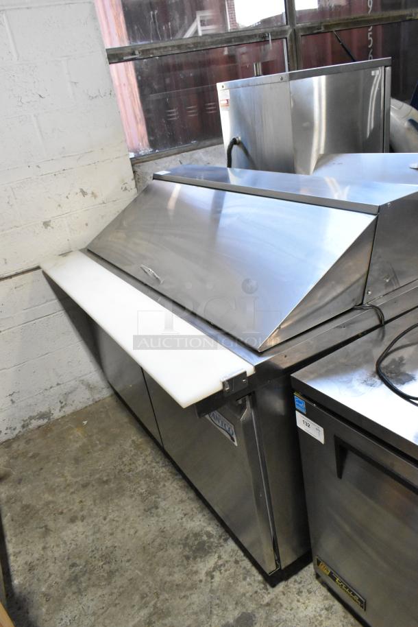Avantco 178SSPT60MHC stainless steel prep table, mega top bain marie, on commercial casters, shown in industrial setting.