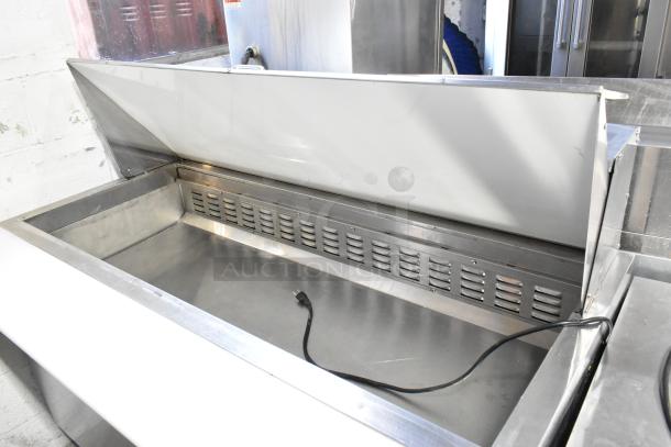 Avantco 178SSPT60MHC stainless steel commercial sandwich prep table with hinged lid, mega top, and commercial casters.