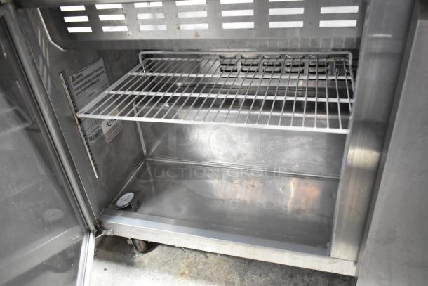 Avantco 178SSPT60MHC stainless steel commercial sandwich salad prep table. Features Bain Marie mega top, shelves, and caster wheels.