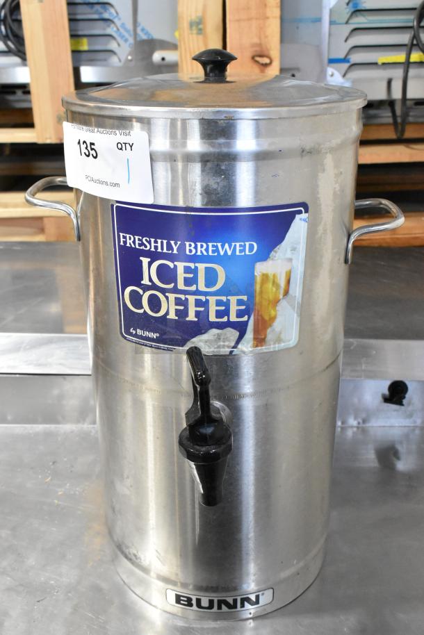 Bunn ICD-3 Stainless Steel Beverage Holder Dispenser with handles and spigot, labeled for iced coffee, in used condition.