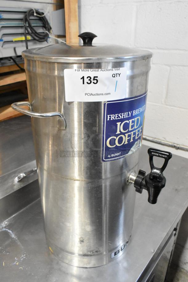 Bunn ICD-3 stainless steel beverage dispenser with labeled "Freshly Brewed Iced Coffee" sign and a black spout.