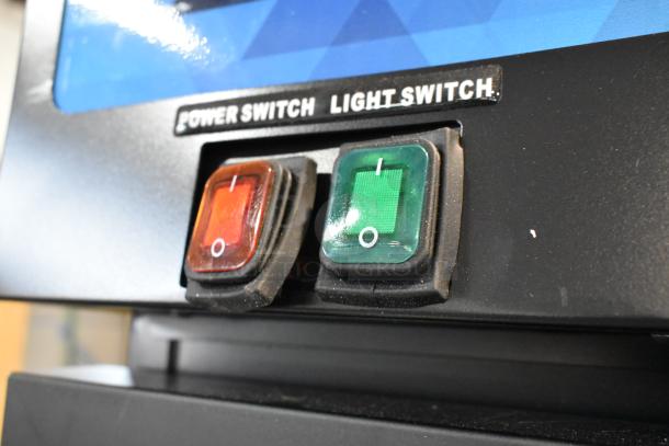 Close-up of KoolMore KM-MDF-1GD-12C freezer controls. Shows power and light switches, labeled accordingly.