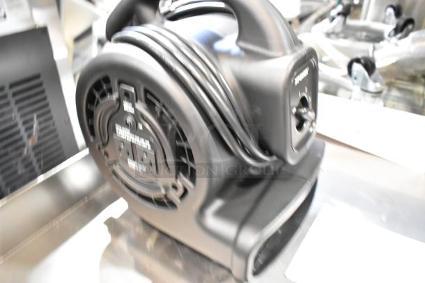 Brand new Xpower P-80A air mover in box. Features durable plastic housing, built-in power outlets, black color.