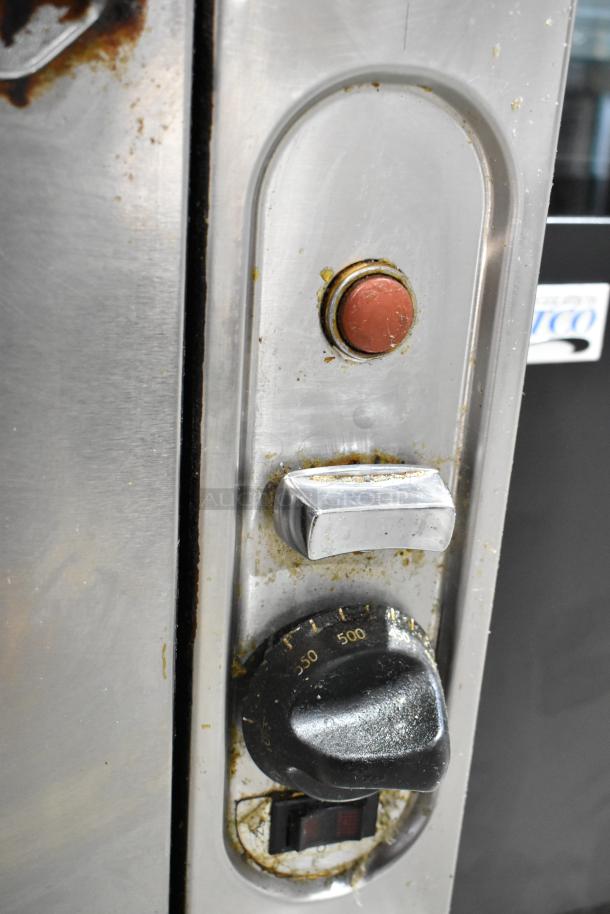 Vulcan VIR1CF stainless steel broiler controls, showing temperature dial, switch, and button. Some visible wear and use marks.