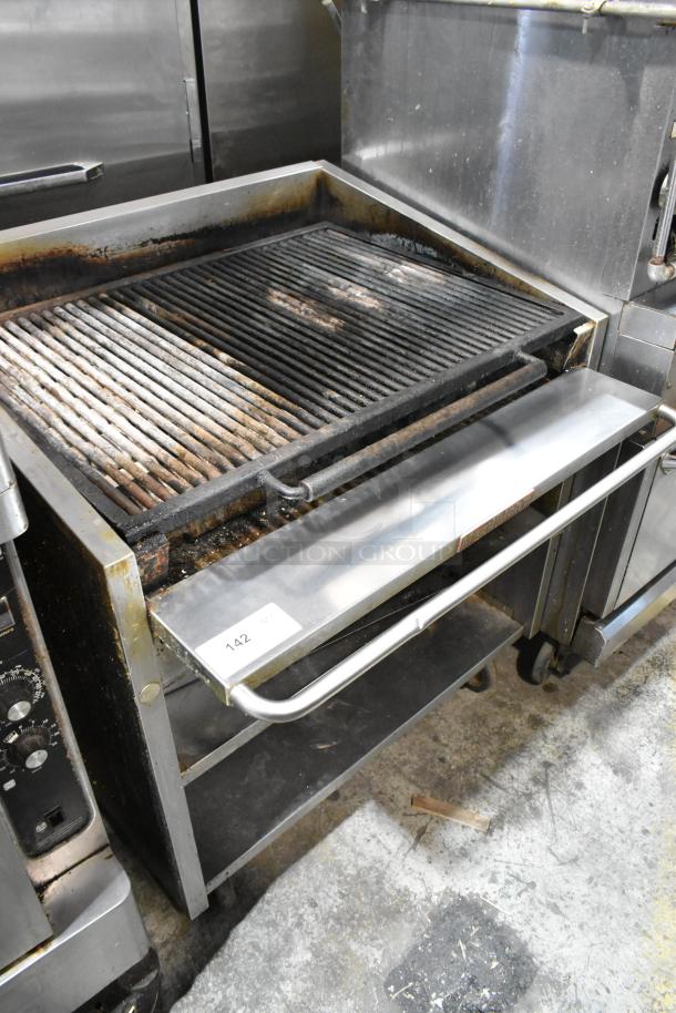 MagiKitch'n 636 stainless steel charbroiler grill, natural gas, commercial casters, under-shelf, wear visible, tag labeled "142".
