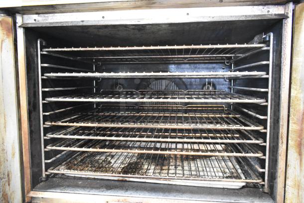 Blodgett stainless steel commercial convection oven interior with metal racks, thermostatic controls, and view-through doors.