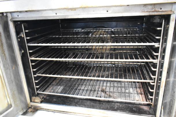 Blodgett stainless steel full-size convection oven with view-through doors, metal racks, thermostatic controls, on casters.