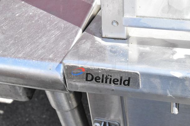 Delfield stainless steel commercial 4 bay steam table with sneeze guard, visible branding, good condition.