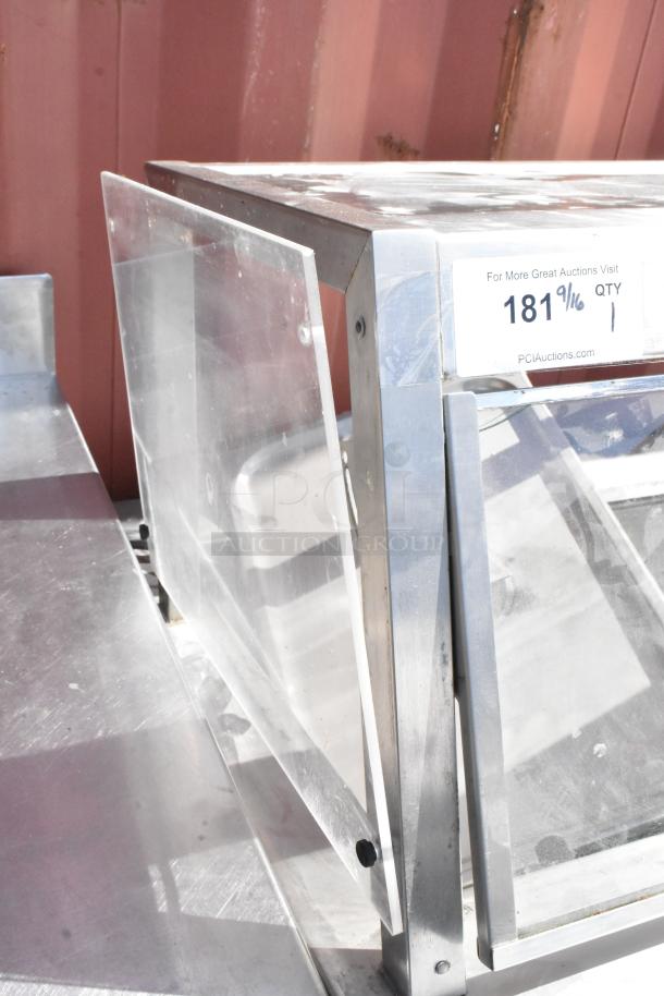 Delfield stainless steel commercial 4 bay steam table with sneeze guard, durable construction, visible auction label.