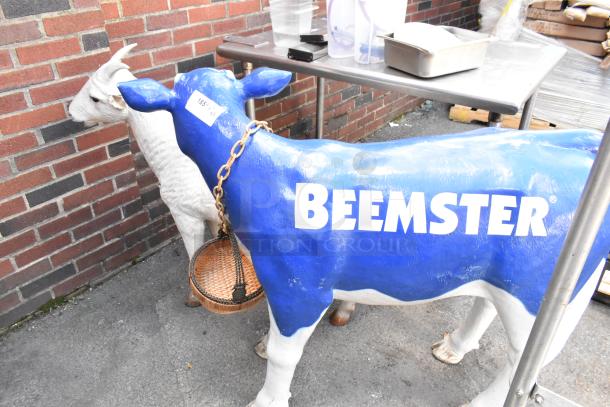 Two statues: a blue "Beemster" cow with a chain and basket, and a white goat. Condition appears well-maintained.