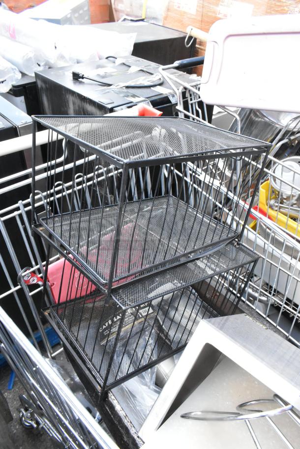 Shopping cart with metal baking pans, cup dispenser, and topping bin inside. Items appear in used condition.