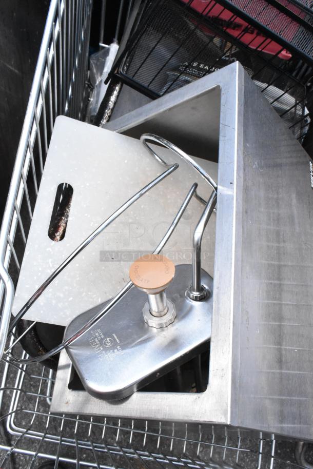 Shopping cart with metal baking pans, cup dispenser, and topping bin. Items appear in good condition.