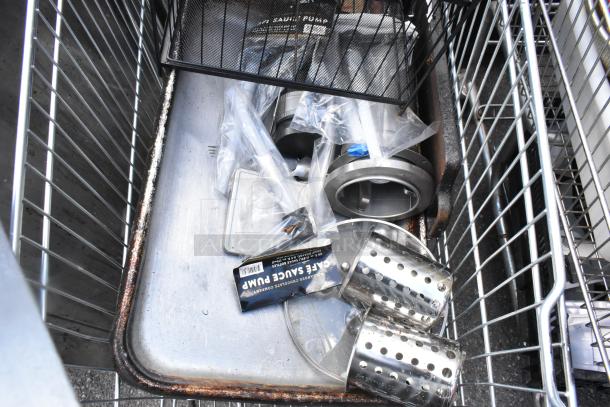Shopping cart containing metal baking pans, a cup dispenser, and a topping bin. Items show wear, ideal for commercial use.