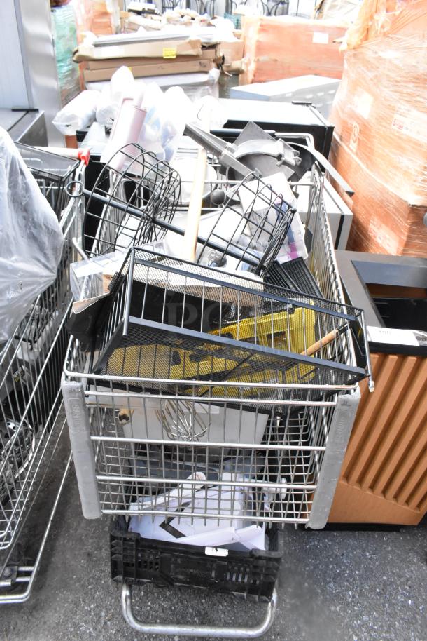 Shopping cart filled with vegetable slicer pieces, bar mats, and various kitchen items. Metal construction, mixed condition.