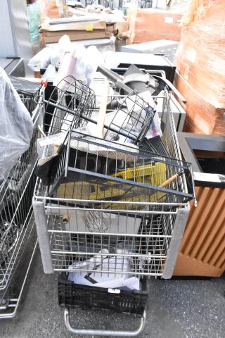 Shopping cart filled with vegetable slicer pieces, bar mats, and various kitchen items. Metal construction, mixed condition.