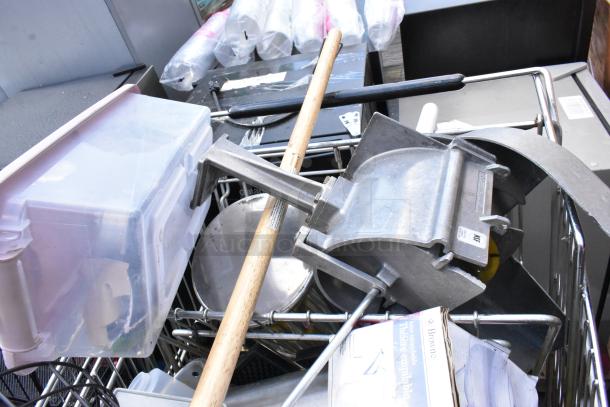 Shopping cart with vegetable slicer pieces, bar mats, and storage containers. Some items are stainless steel. Mixed conditions.