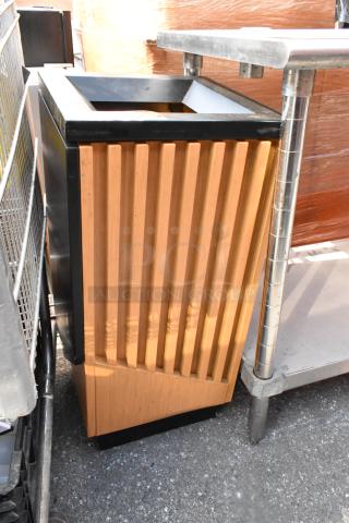 Wooden trash can shell with vertical slats, steel top frame, showing minimal wear. Ideal for interior or exterior use.