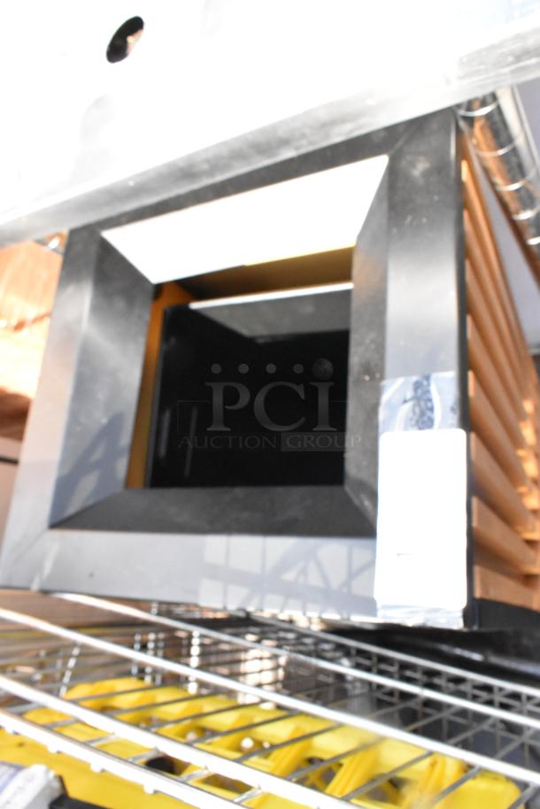 Black trash can shell with square opening and metal frame, shows minor wear. Suitable for indoor or outdoor use. Label partially visible.