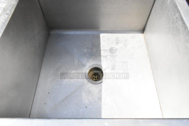 Stainless steel single bay sink, lightly used, visible drain, durable construction, ideal for kitchen or utility use.