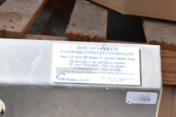 Stainless steel single bay sink with Elkay branding. Features Footworks faucet controllers instructions label for operation.