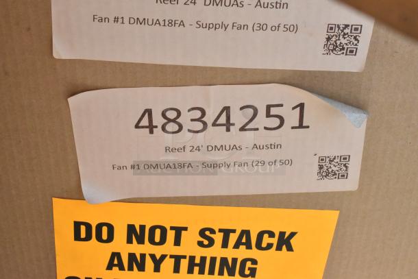 Two new CaptiveAire DMUA18FA metal rooftop exhaust fans in labeled packaging, warning not to stack.