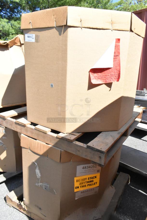 Two sealed boxes containing CaptiveAire DMUA18FA metal rooftop exhaust mushroom fans on pallets, labeled "Do Not Stack."