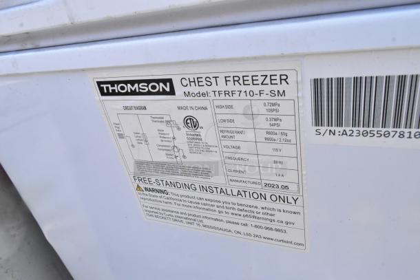 Label on Thomson TFRF710-F-SM Chest Freezer, 115 Volts, 1 Phase. Model details, circuit diagram, and warning are visible.