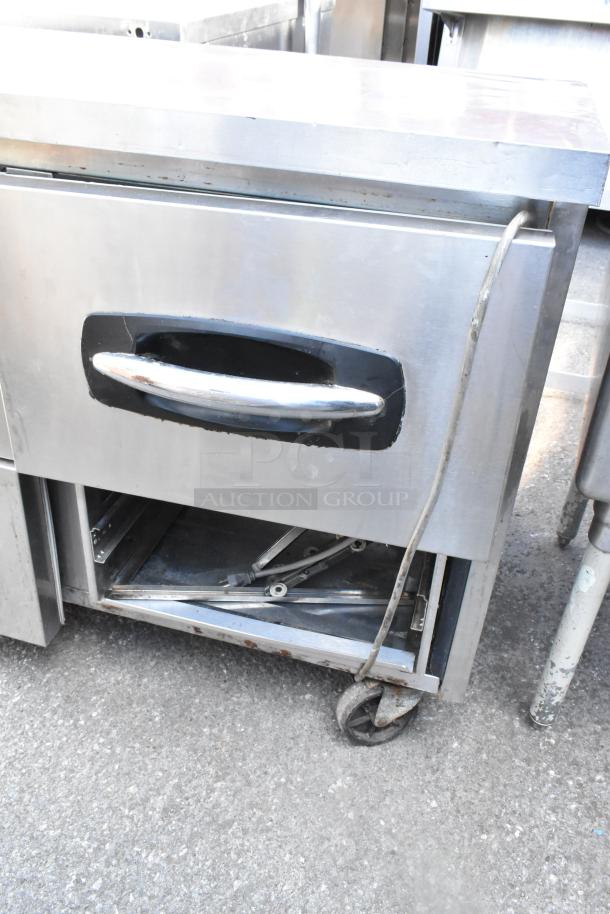Norlake UR72 stainless steel 6-drawer undercounter cooler with commercial casters, 115V, 1 phase. Visible wear on exterior.