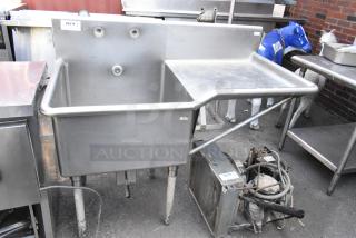 Stainless steel single bay sink with right side drain board, includes visible label "204 QTY 1," in used condition.