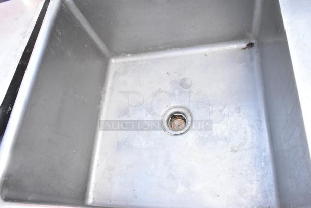 Stainless steel single bay sink with right side drain board, showing wear. Ideal for commercial kitchen use.