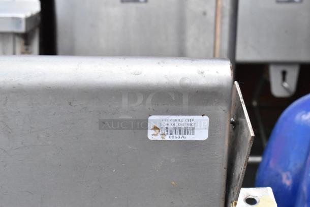 Stainless steel single bay sink with right side drain board, worn condition, tag indicates Peekskill City School District.