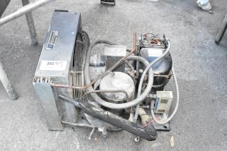 Copeland REK3-0125-PFV-959 compressor, 208/230V, 1 phase, with visible labeling. Used condition on outdoor surface.