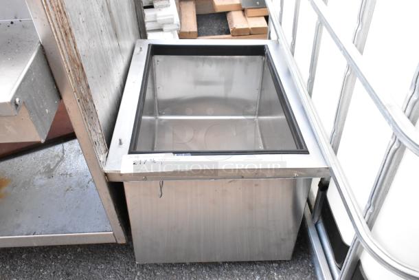 Stainless steel drop-in ice bin, rectangular shape, with visible tag showing item ID; appears in good condition.