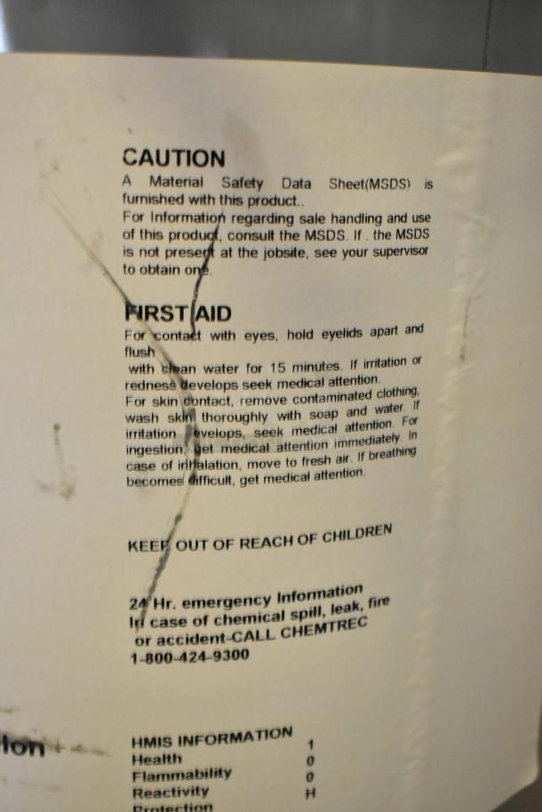 Label on chemical container showing safety instructions, first aid, and emergency contact information for Pro Guard chemicals.