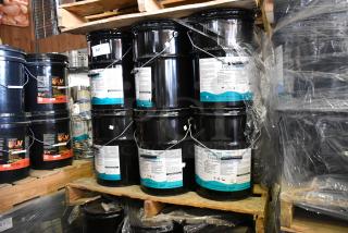 23 Pro Guard chemical containers, including 5-gallon 9101 Moisture Cure Liquid Rubber, stacked on a pallet.